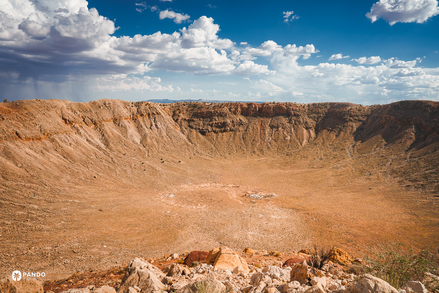 The bowl of Barringer Crater seen from its rim in Arizona, under scattered cloud.