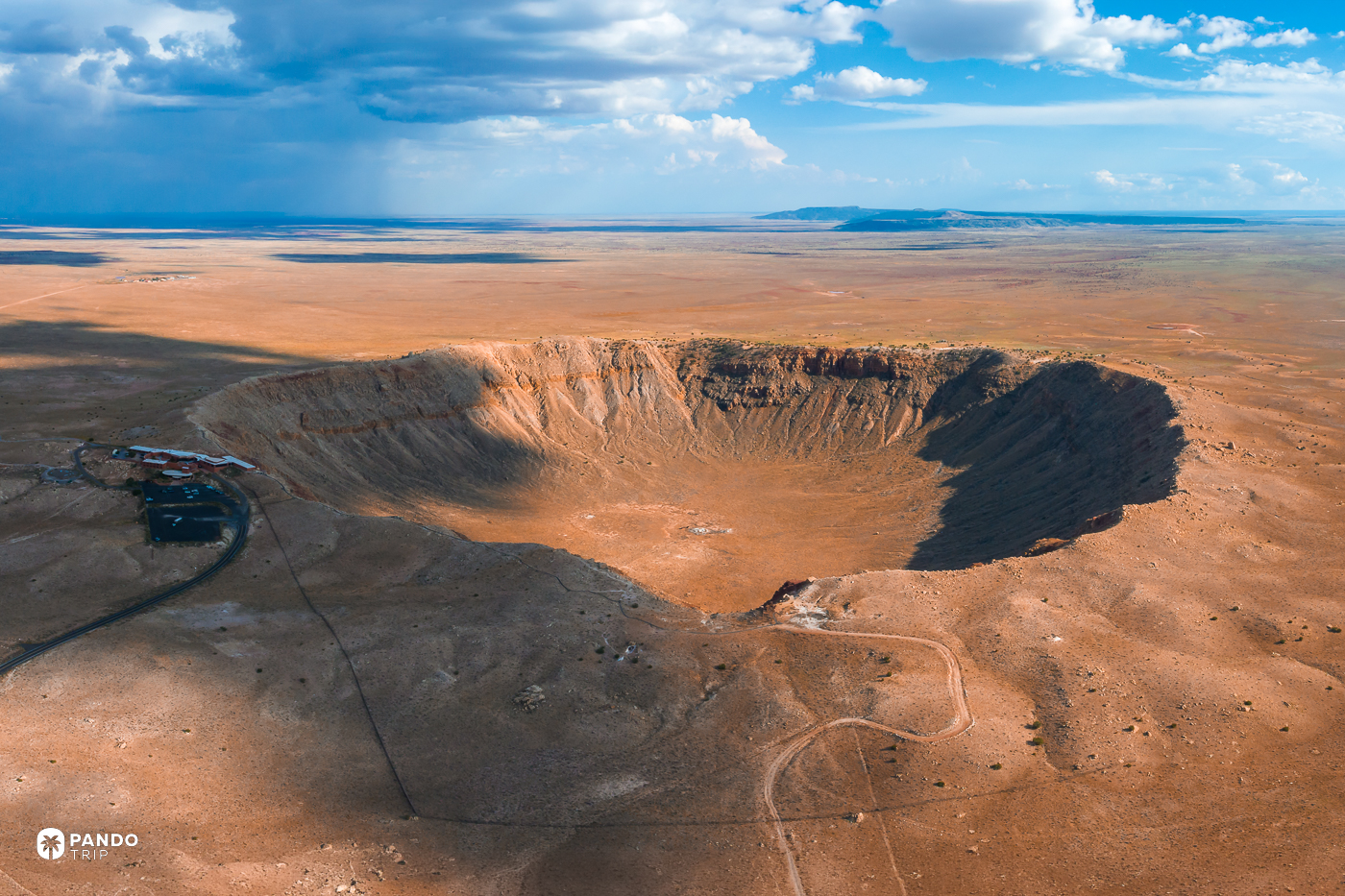 Barringer Crater from the air, with the visitor complex and access road on its northern rim.