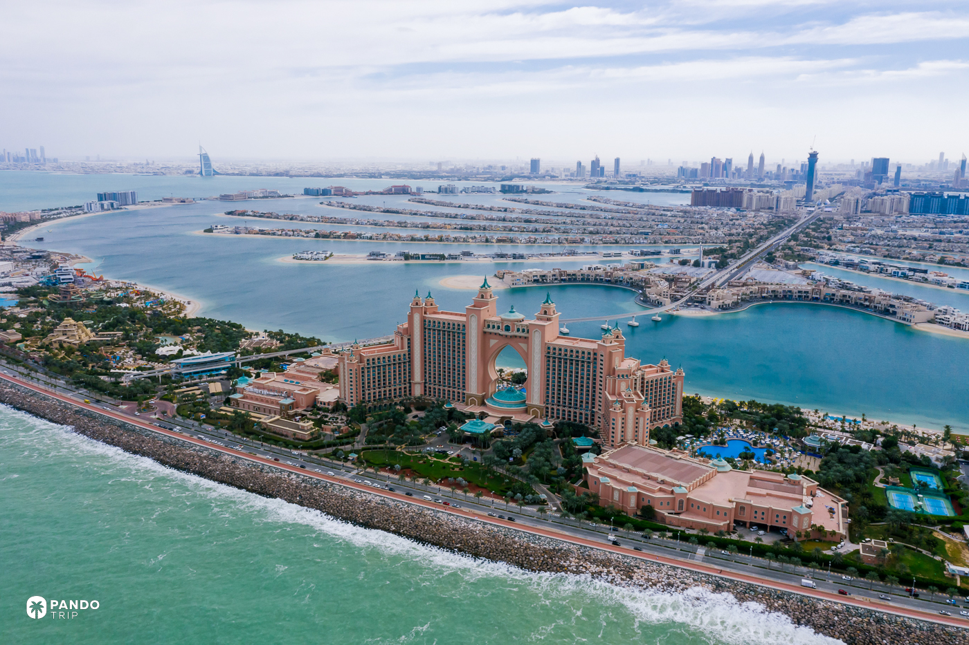 The Atlantis hotel on Palm Jumeirah's crescent, with the island's fronds and the Dubai skyline behind.