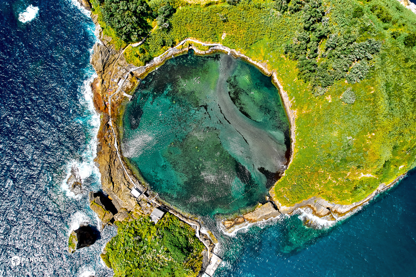 The flooded crater of the Vila Franca islet from directly above, its pool opening to the sea through one channel.