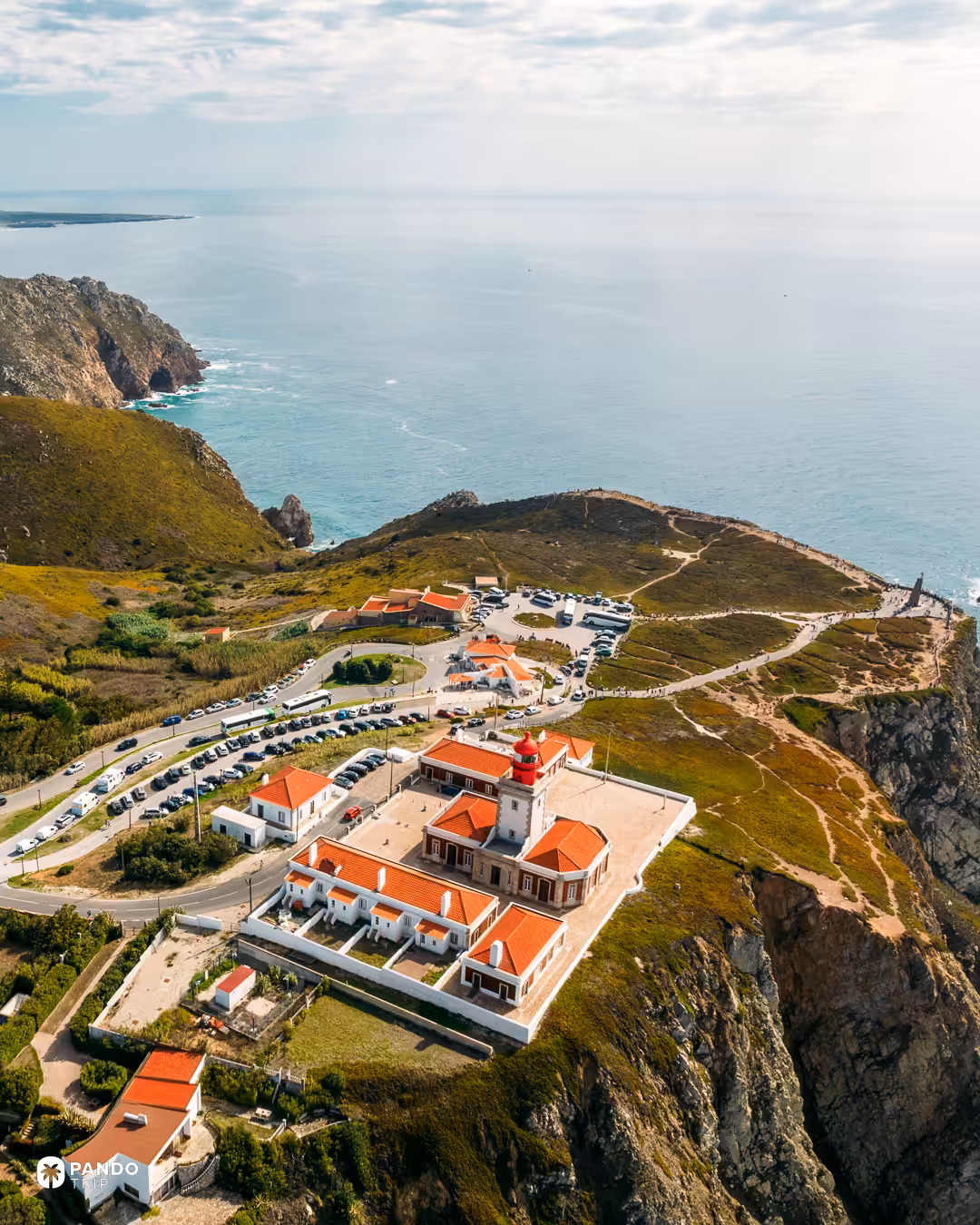 Aerial view of the Cabo da Roca lighthouse, car parks and coaches above the Atlantic